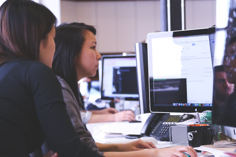 A woman trains an aircraft technician to use remote aviation inspection software