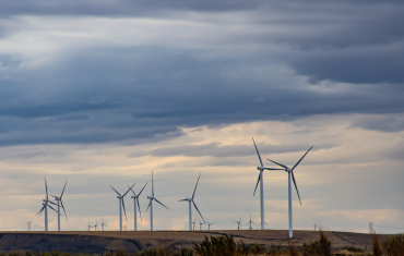 wind turbine farm and cloudy sky