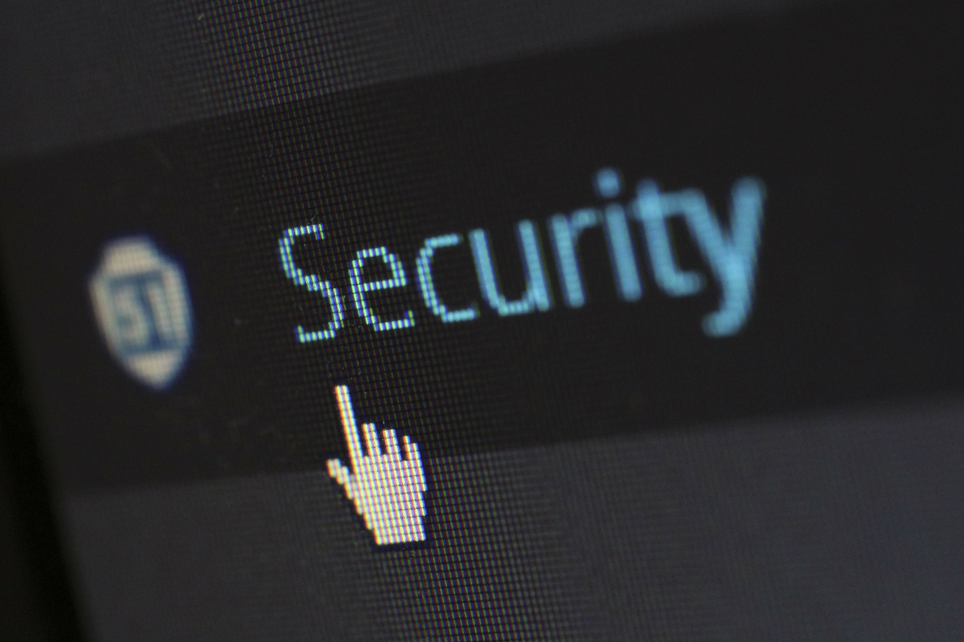 security-265130_1920 Screenshot of a dark page with blue text 'security' and a hand cursor hovering beneath text